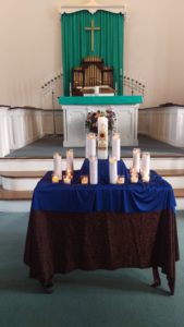 Organ in background and table with candles in foreground