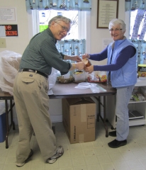 Marll & Carol Sheldon bagging bread for the Food Shelf.